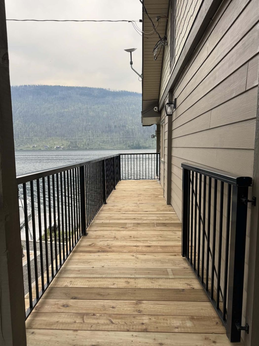 Lakefront deck walkway with black railings